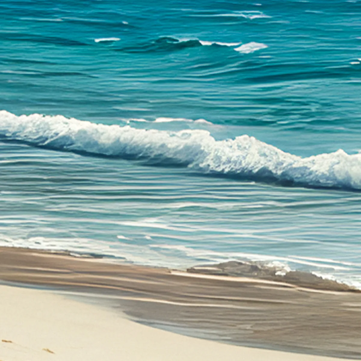 Turquoise tropical waves washing onto white sand