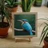 Atmospheric jungle kingfisher artwork in cozy living space